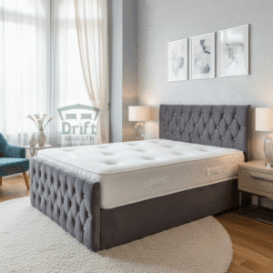 The Aspire divan bed in a sleek charcoal grey velvet, highlighting its deep button-tufting and practical side-drawer storage.
