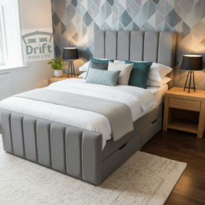 The Clarence bed in a modern grey fabric, featuring a fully panelled frame with two large divan-style drawers pulled out from the base for easy access.