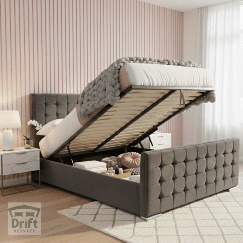 The contemporary Cube ottoman bed in charcoal grey, with its mattress lifted to showcase the deep storage area, highlighting its unique geometric cubed upholstery.