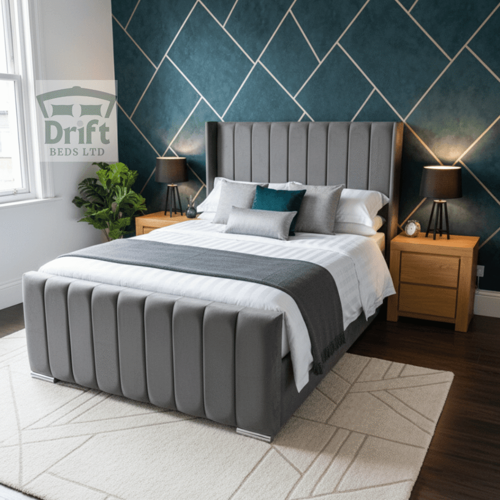 The Ottoman Clarence Wing Bed in Grey The sophisticated Clarence Wingback ottoman bed in a chic grey velvet, lifted to showcase its expansive hidden storage.