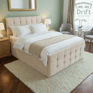 The luxurious Raven ottoman bed in a bright cream fabric, with its mattress lifted to display a deep and hidden storage compartment.